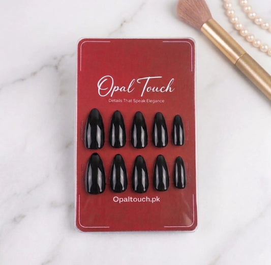 Opal Touch nail extensions on a red card with makeup items in the background